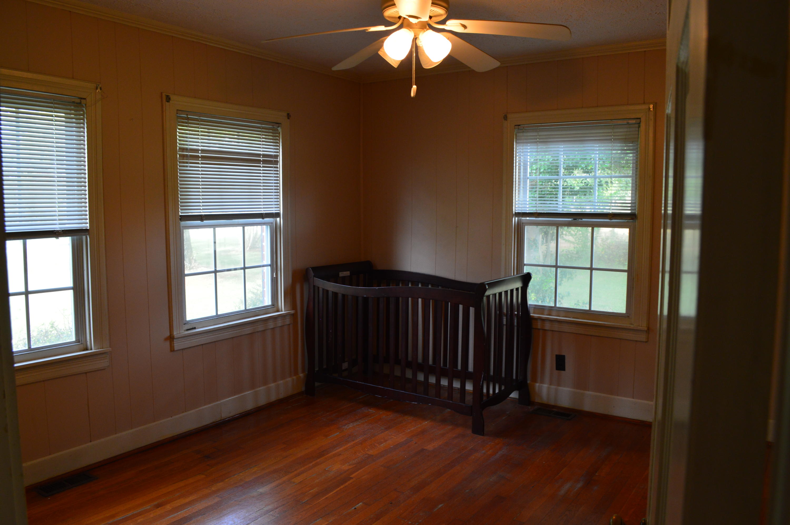 8745 Callands Road Chatham, VA 24531 - Photo 13 of 37 a view of an empty room with wooden floor and a window