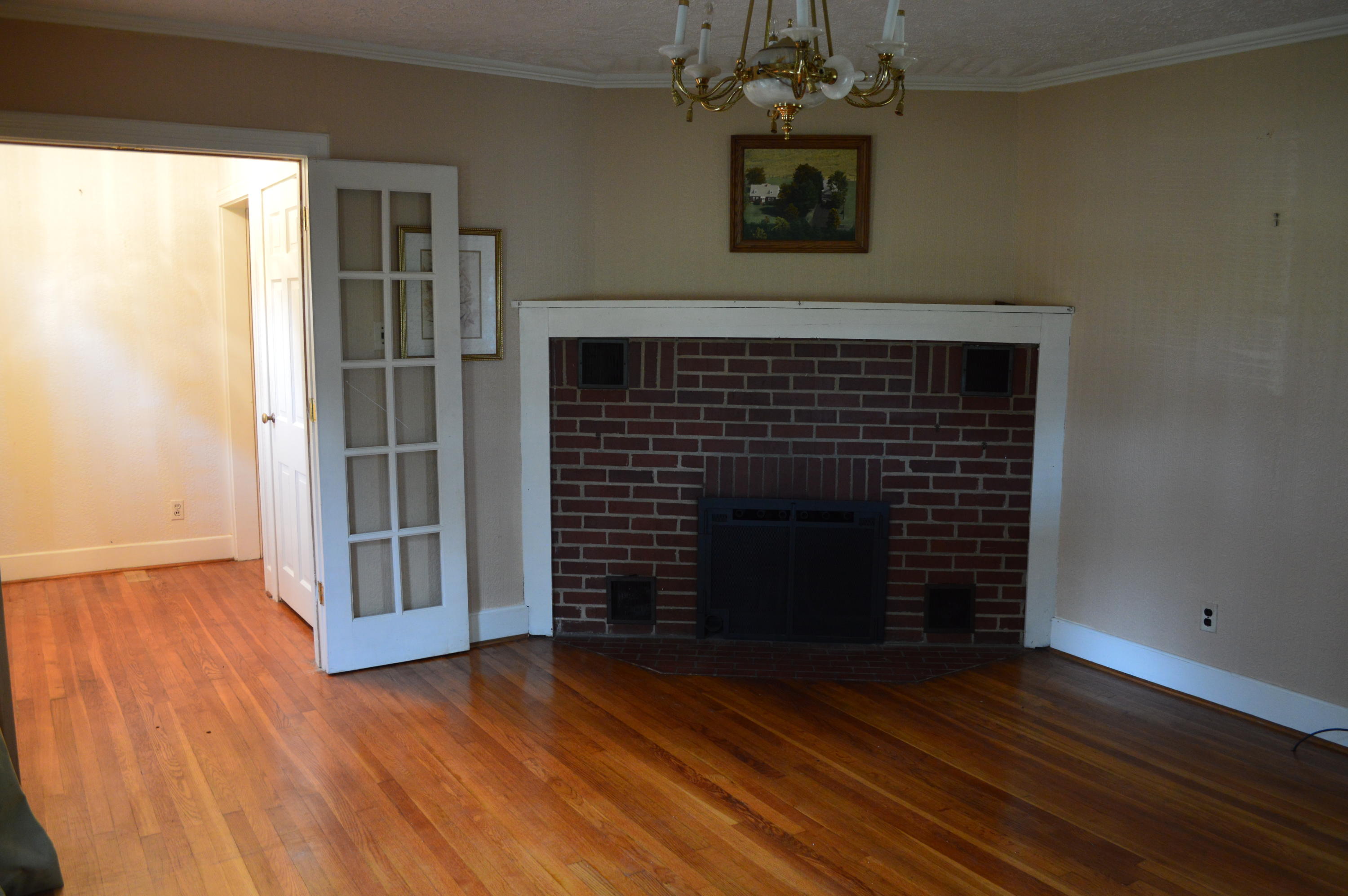 8745 Callands Road Chatham, VA 24531 - Photo 15 of 37 a view of a livingroom with wooden floor and a fireplace