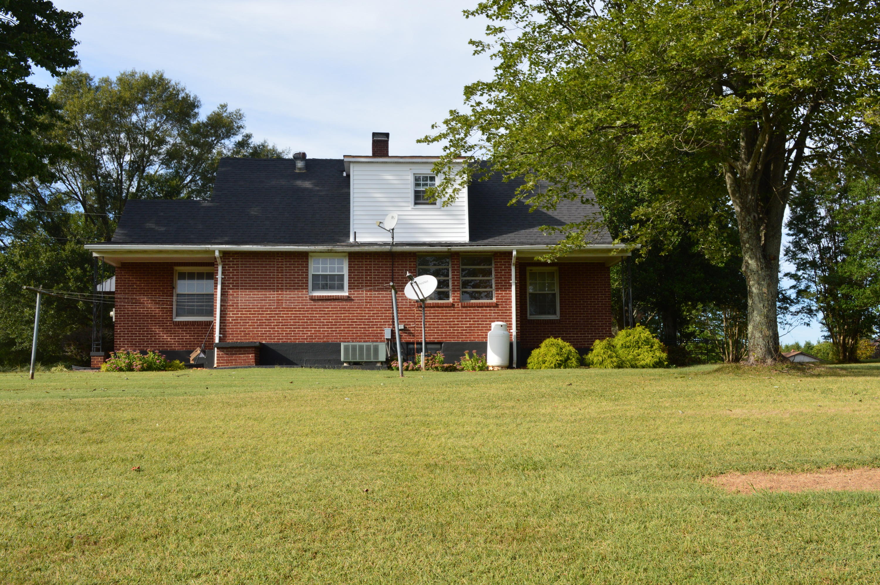 8745 Callands Road Chatham, VA 24531 - Photo 4 of 37 a view of a house with a yard and large tree