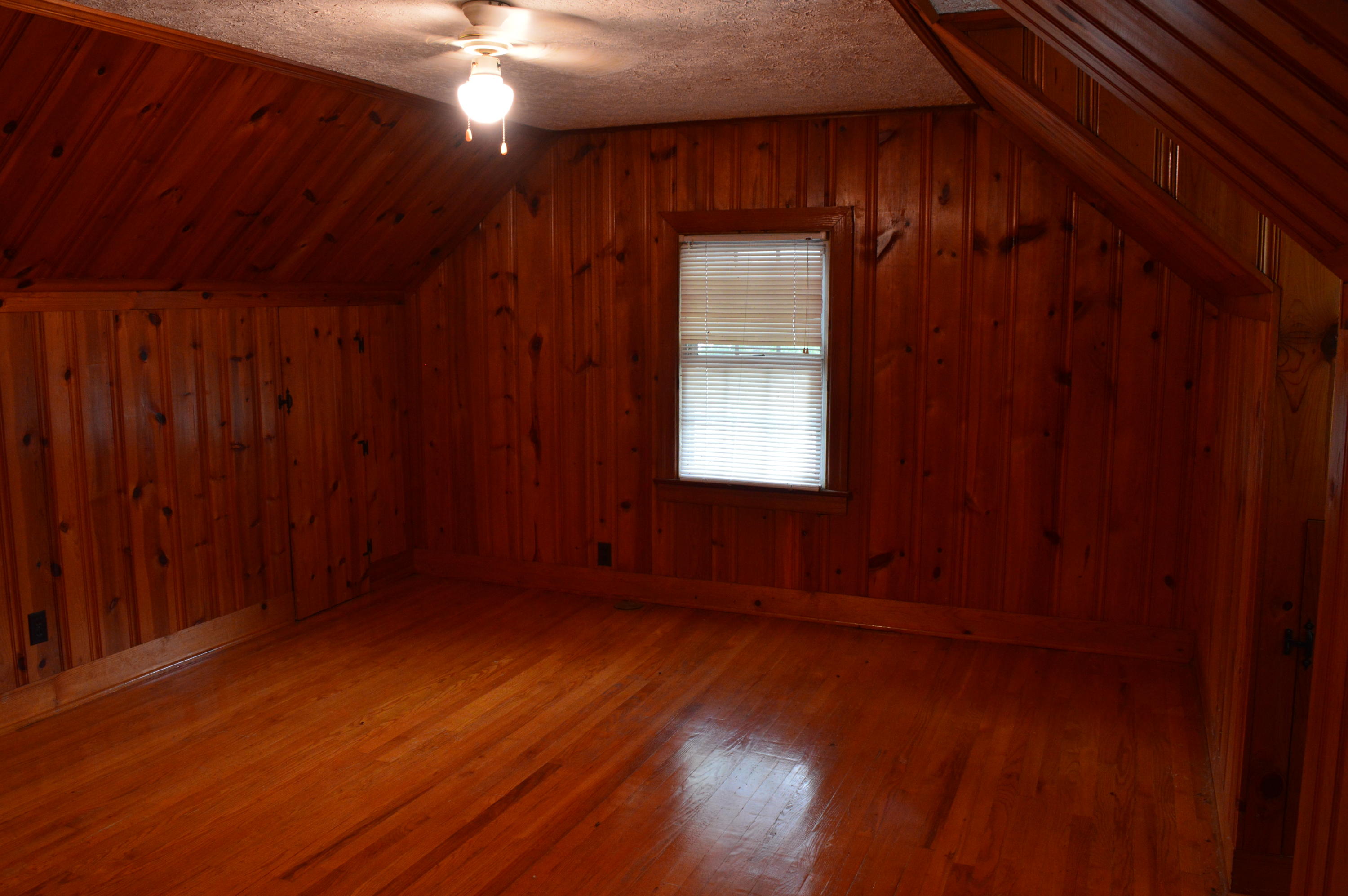 8745 Callands Road Chatham, VA 24531 - Photo 32 of 37 an empty room with wooden floor and windows