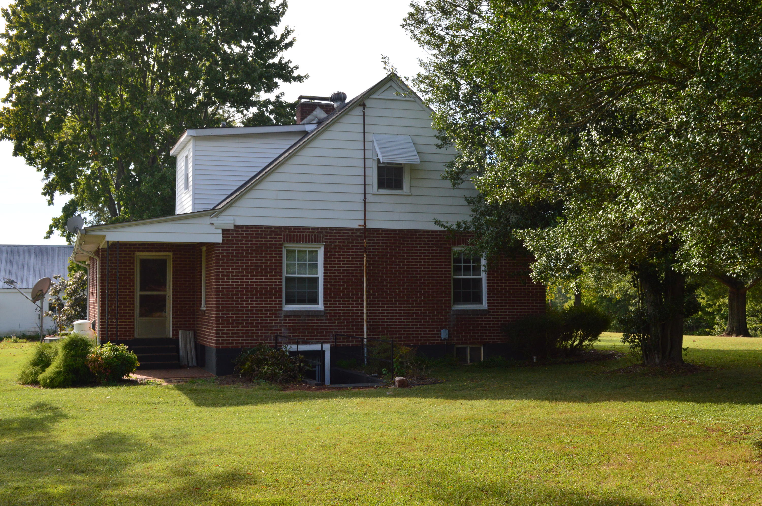 8745 Callands Road Chatham, VA 24531 - Photo 5 of 37 a view of a house with a yard and a large tree