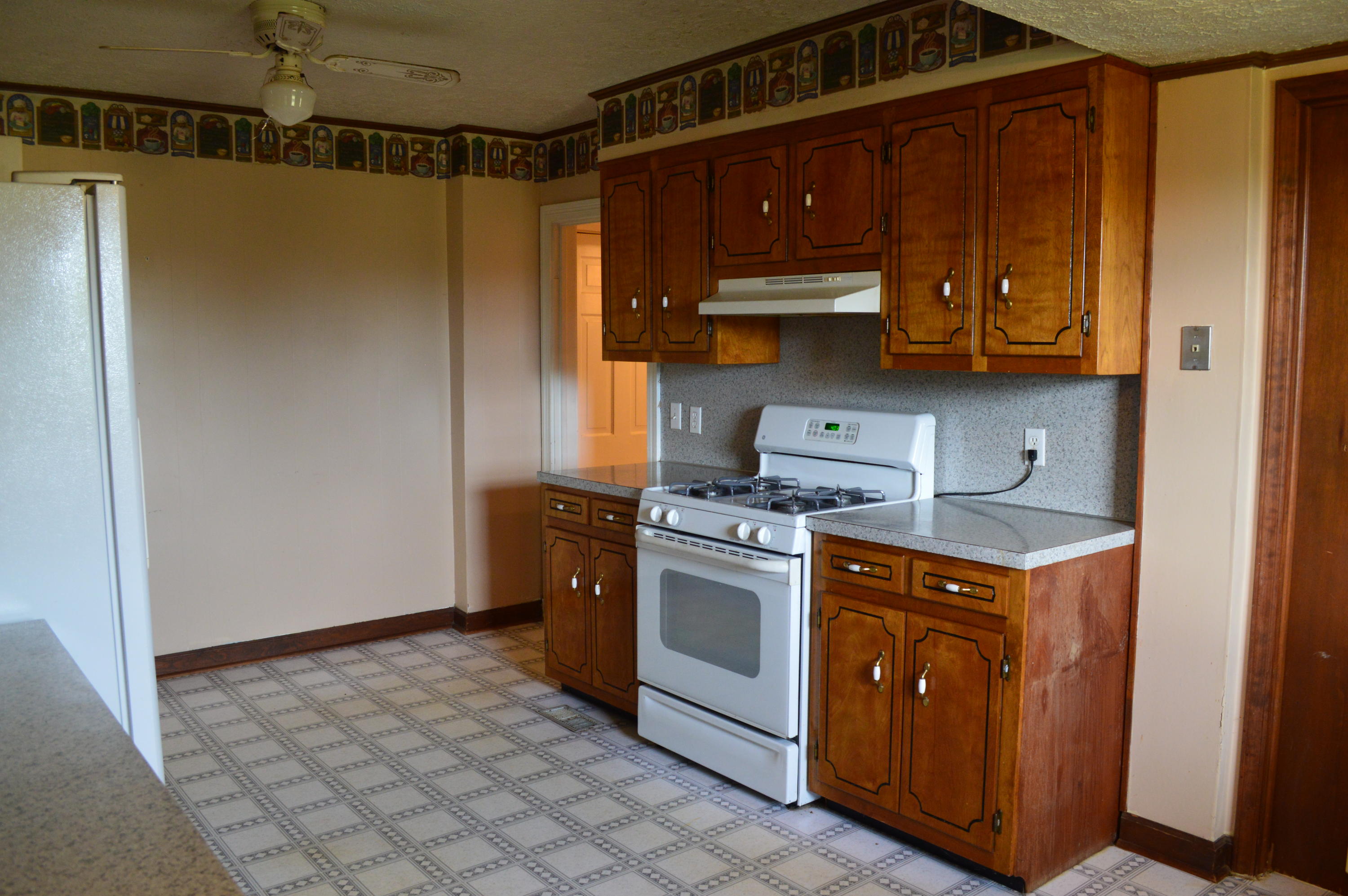 8745 Callands Road Chatham, VA 24531 - Photo 7 of 37 a kitchen with a stove and a cabinet