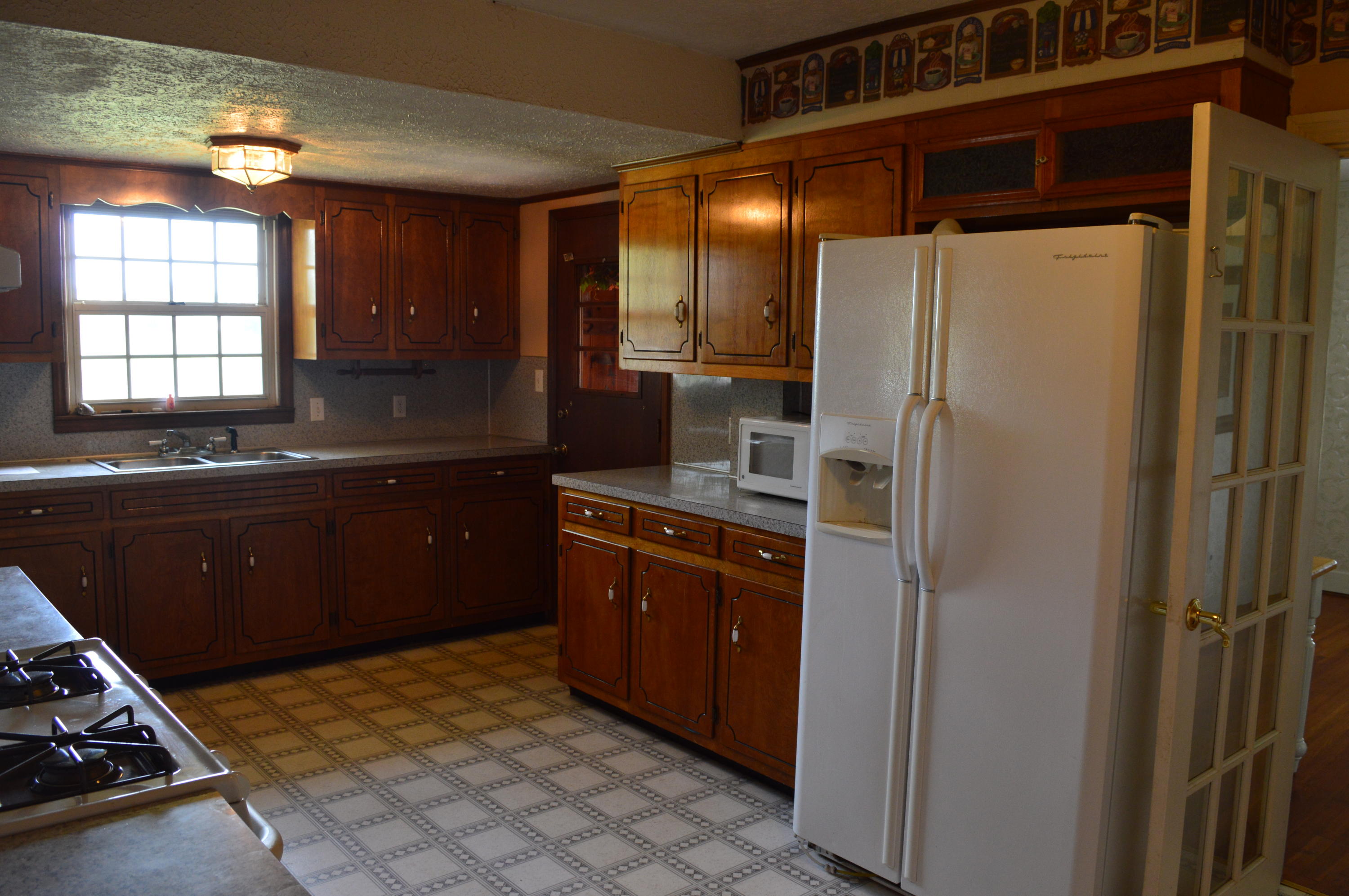 8745 Callands Road Chatham, VA 24531 - Photo 9 of 37 a kitchen with stainless steel appliances a refrigerator and a sink