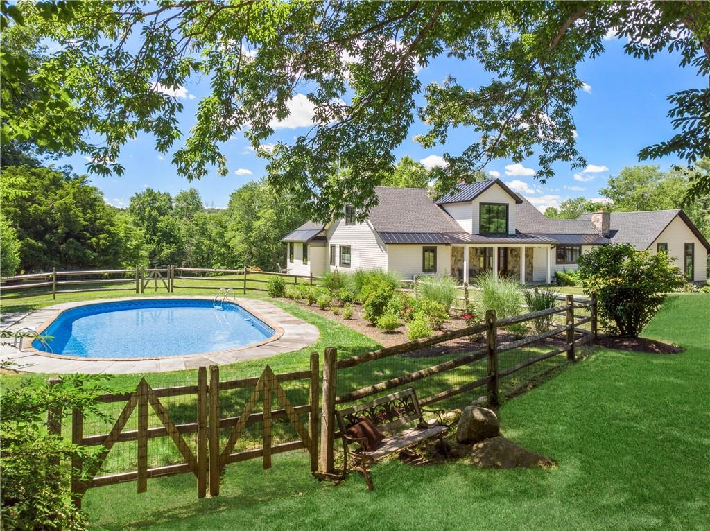 a view of an house with backyard space and sitting area