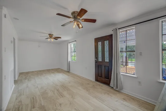 a kitchen with kitchen island granite countertop a stove sink and refrigerator