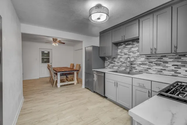 a kitchen with stainless steel appliances a stove sink microwave and refrigerator