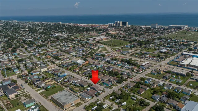 a front view of a house with a garden and garage