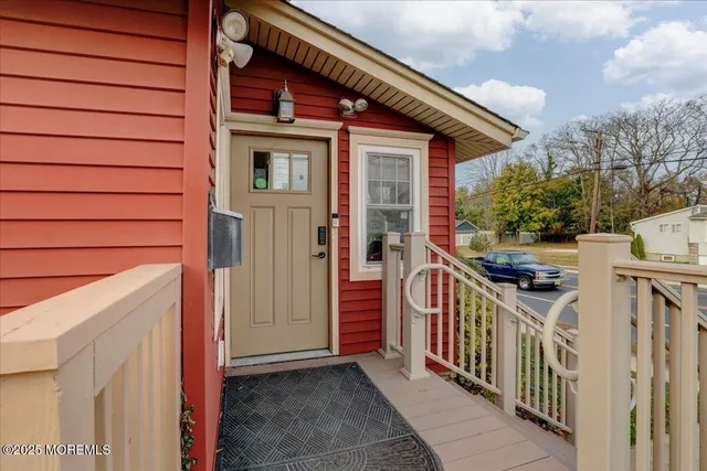 a view of a house with a small yard and wooden fence