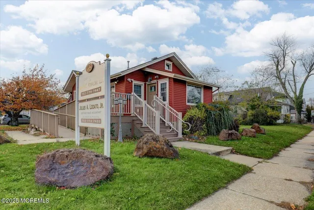 a front view of a house with a garden