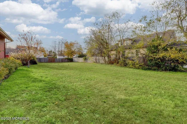 a view of a field of grass and trees