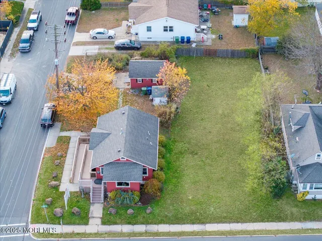 an aerial view of a house with a lake view