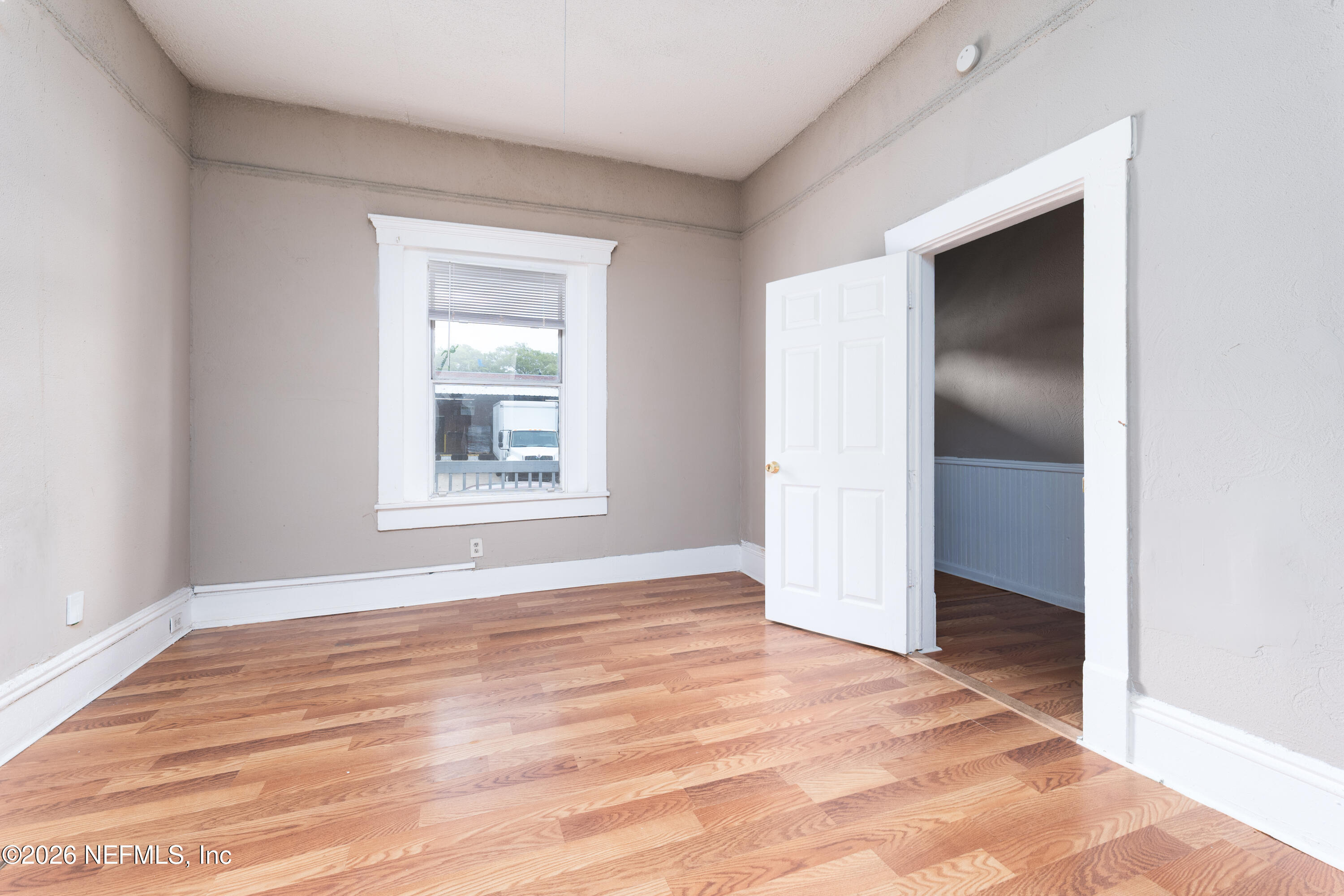 1222 Clark Street Jacksonville, FL 32206 - Photo 11 of 16 a view of an empty room with wooden floor and a window