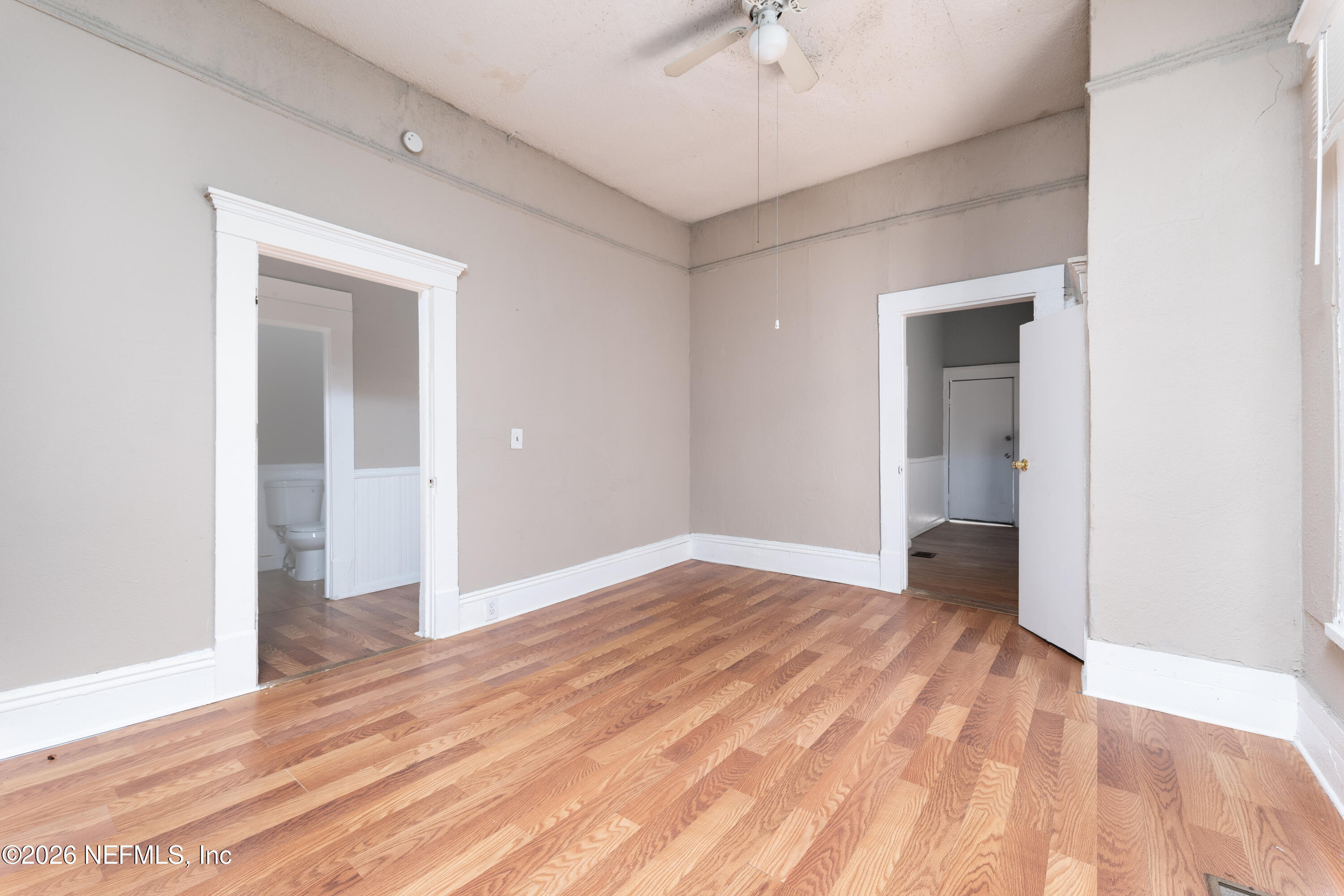 1222 Clark Street Jacksonville, FL 32206 - Photo 4 of 16 an empty room with wooden floor and chandelier fan