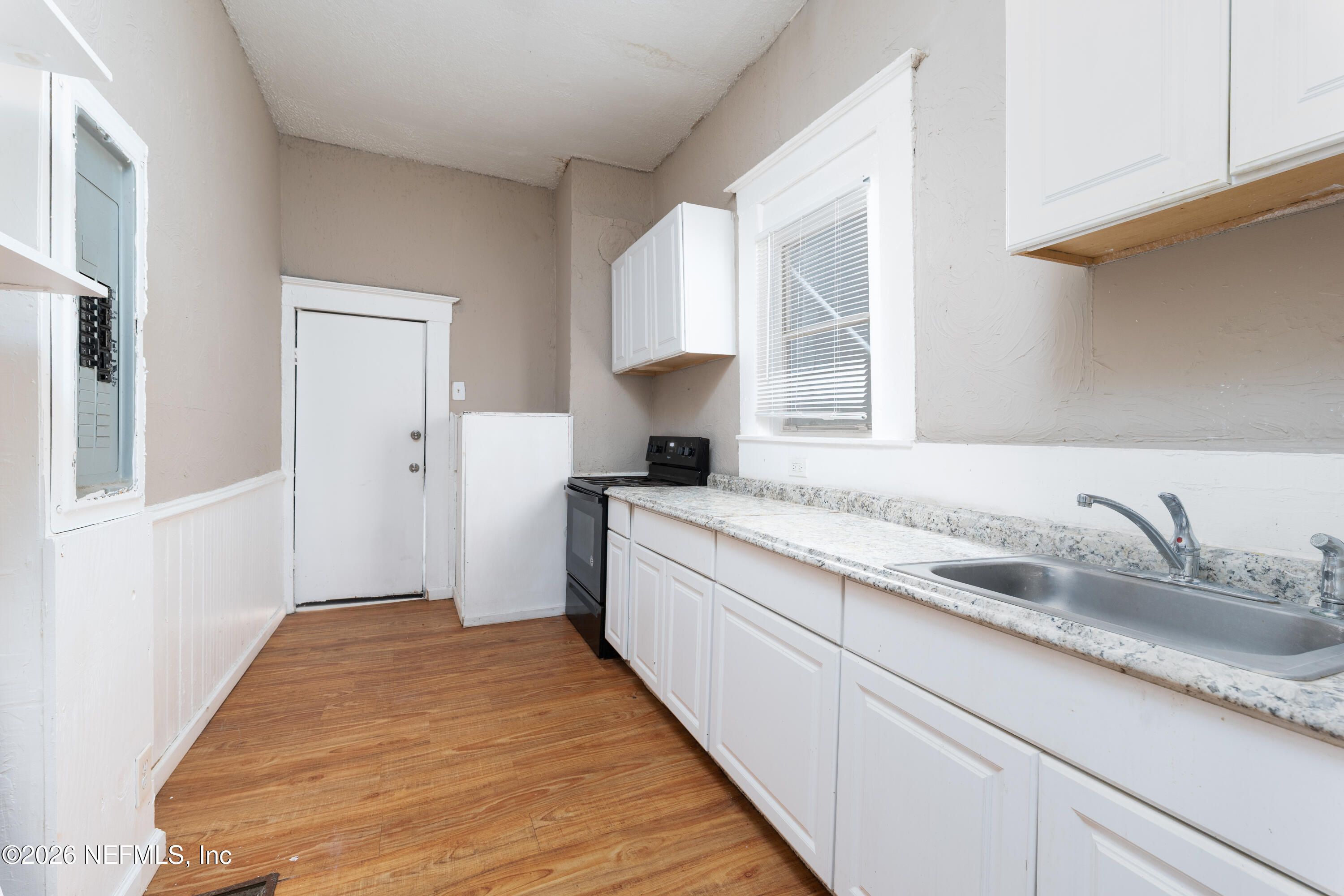 1222 Clark Street Jacksonville, FL 32206 - Photo 5 of 16 a bathroom with a granite countertop sink a toilet and mirror