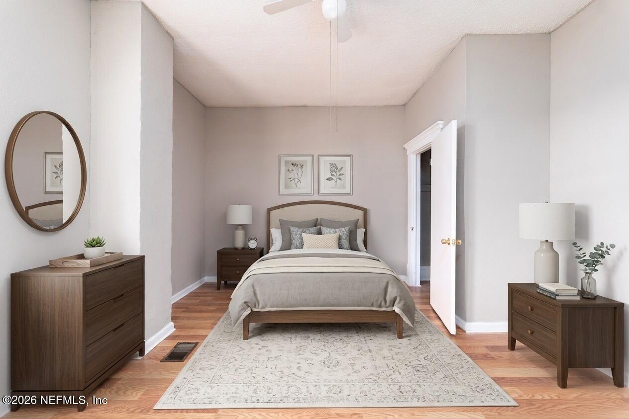 1222 Clark Street Jacksonville, FL 32206 - Photo 6 of 16 a bedroom with bed and a chandelier
