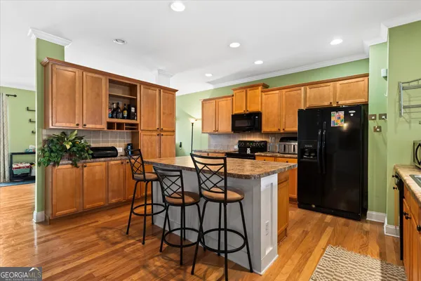 a kitchen with a stove a refrigerator and a dining table