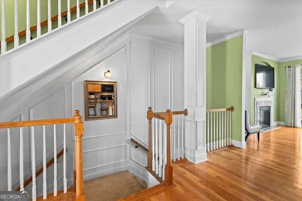 a view of a balcony with wooden floor and fence