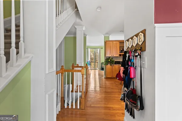 a kitchen with stainless steel appliances kitchen island granite countertop a stove top oven a sink a dining table and chairs with wooden floor