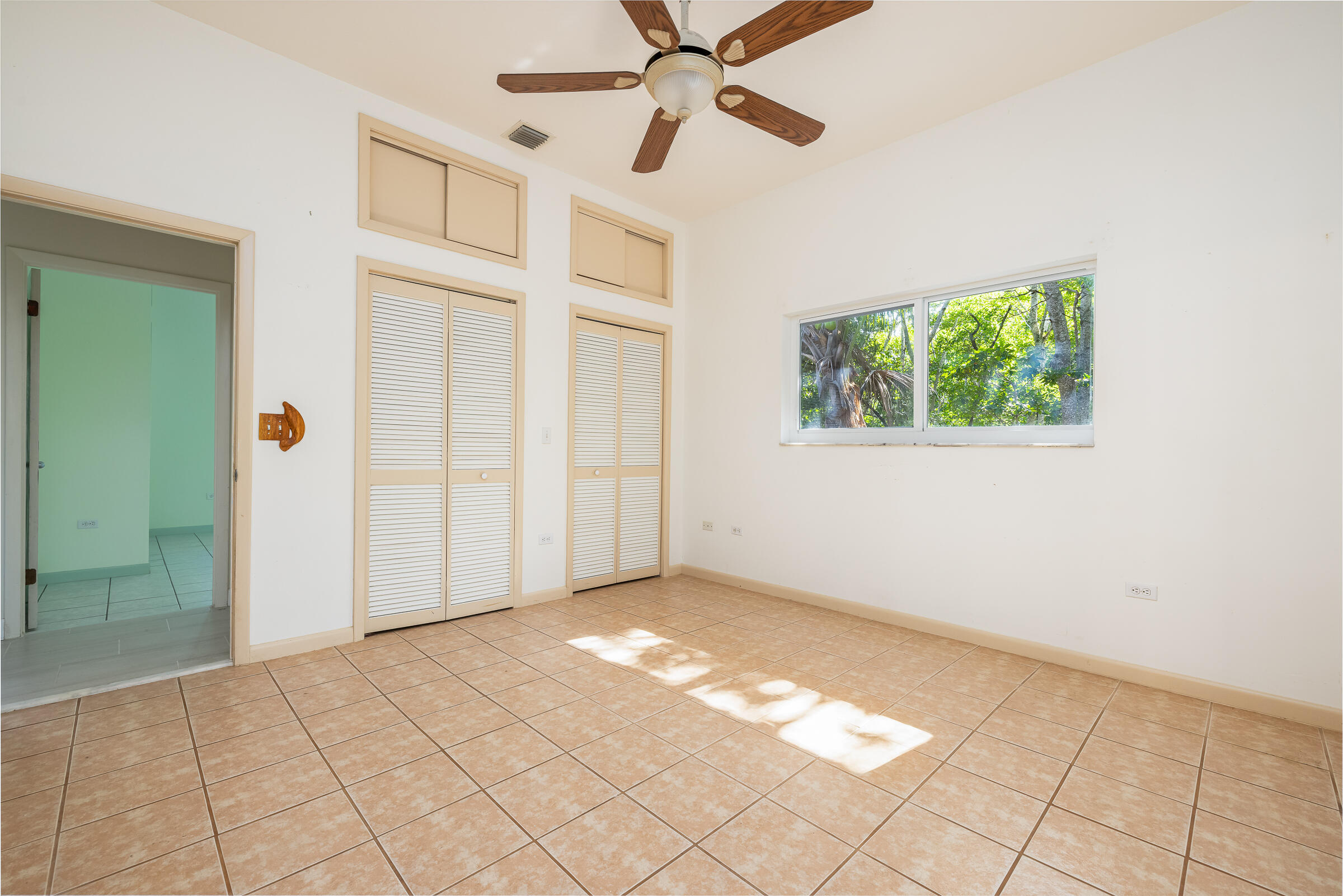 132 Galleon Road Islamorada, FL 33036 - Photo 20 of 38 a view of an empty room with window and chandelier fan