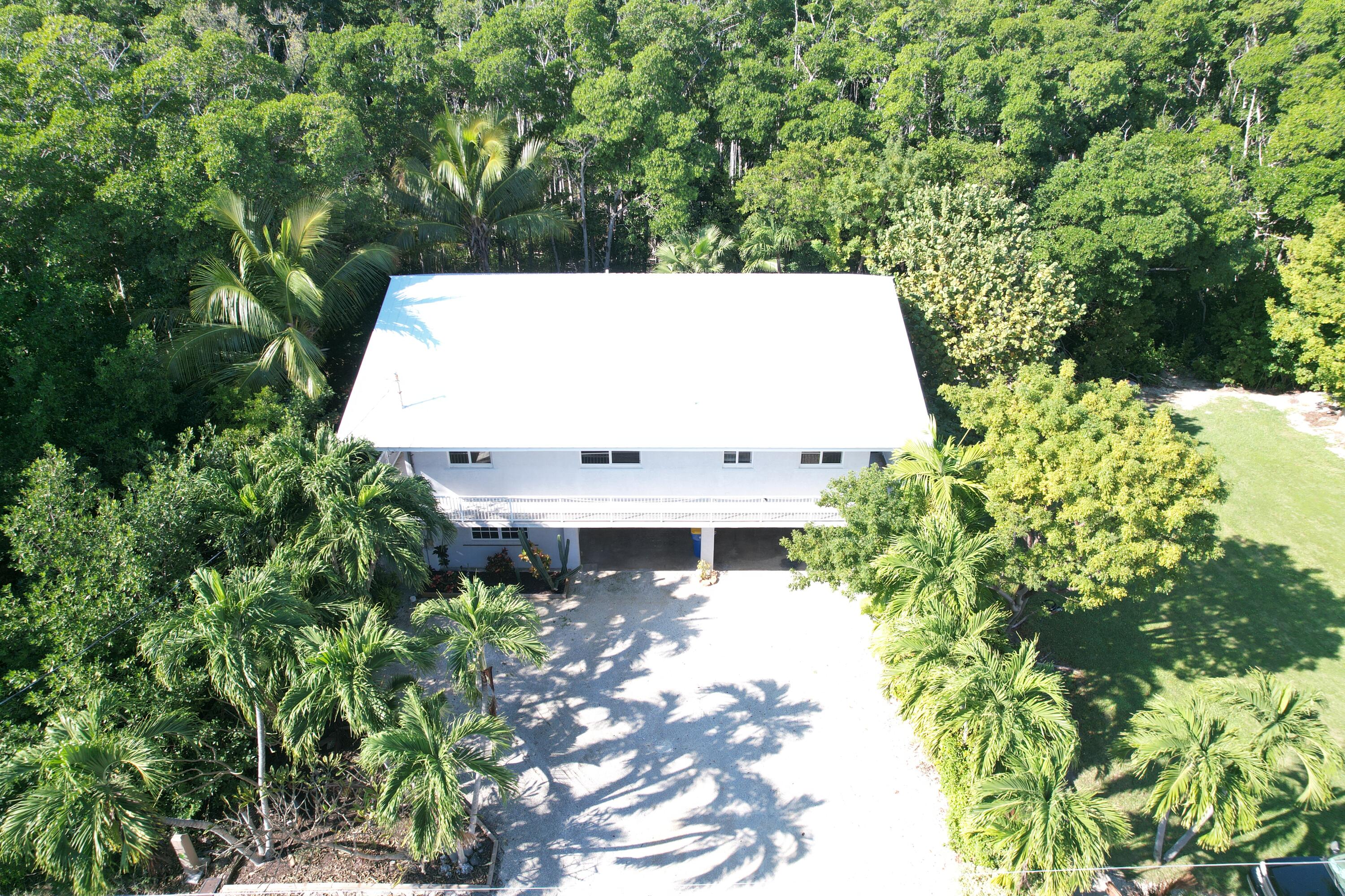 132 Galleon Road Islamorada, FL 33036 - Photo 7 of 38 a view of a yard with plants and large trees