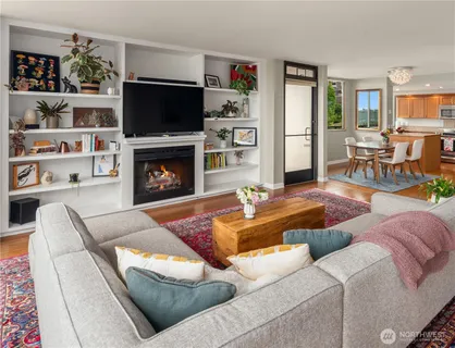 a living room with furniture a flat screen tv and a fireplace