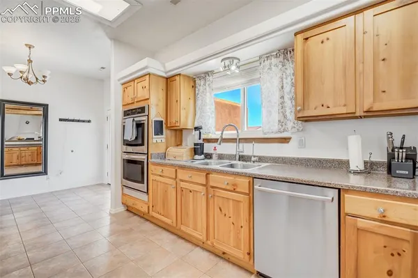 a large kitchen with stainless steel appliances lots of counter top space