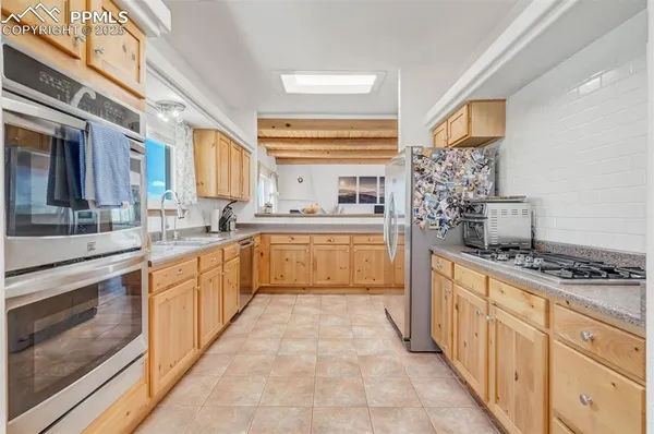 a stove top oven sitting inside of a kitchen