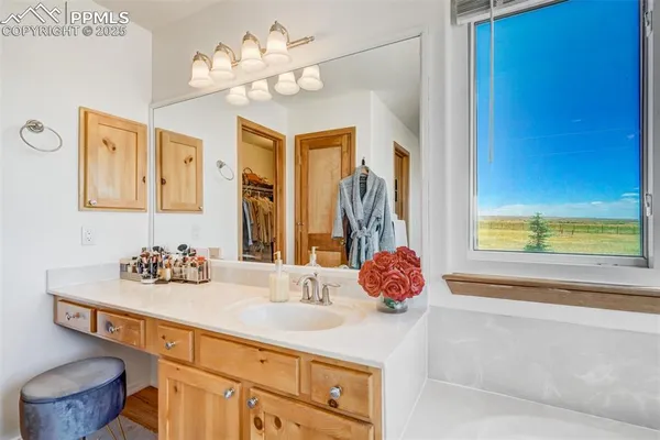 a bathroom with a tub sink and mirror