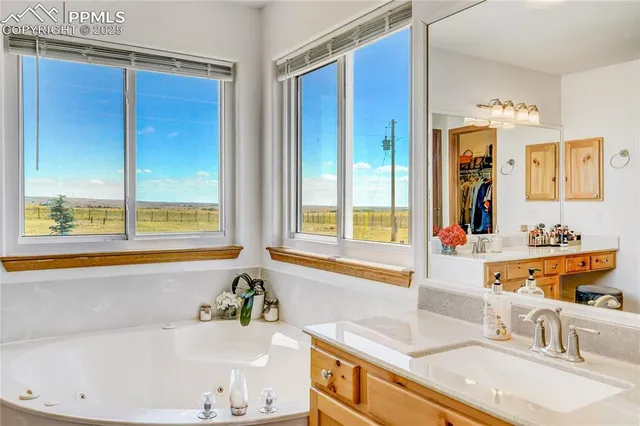 a spacious bathroom with a shower a sink and a mirror