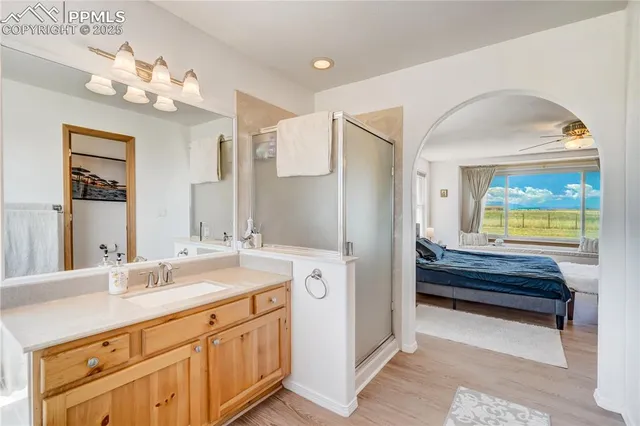 a bedroom with a bed and a painting on the wall