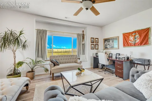 a living room with furniture and wooden floor