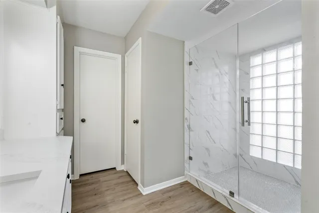 a spacious bathroom with a double vanity sink and mirror