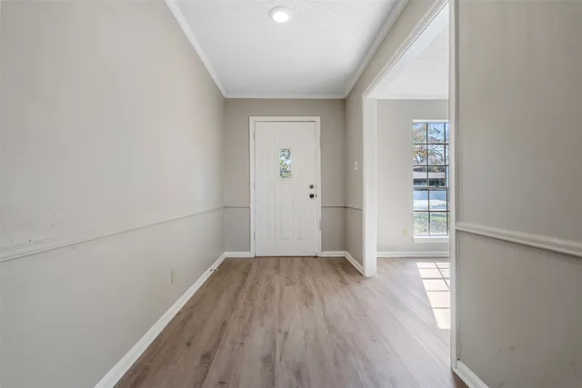 wooden floor in an empty room with a window