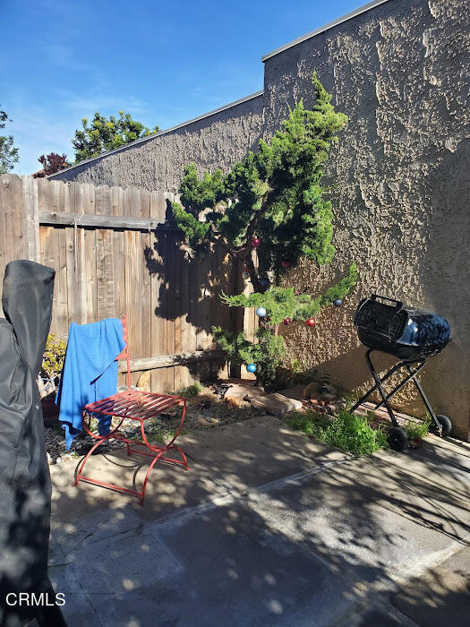 3077 Kelp Lane, Unit 108 Oxnard, CA 93035 - Photo 12 of 15 a backyard of a house with table and chairs