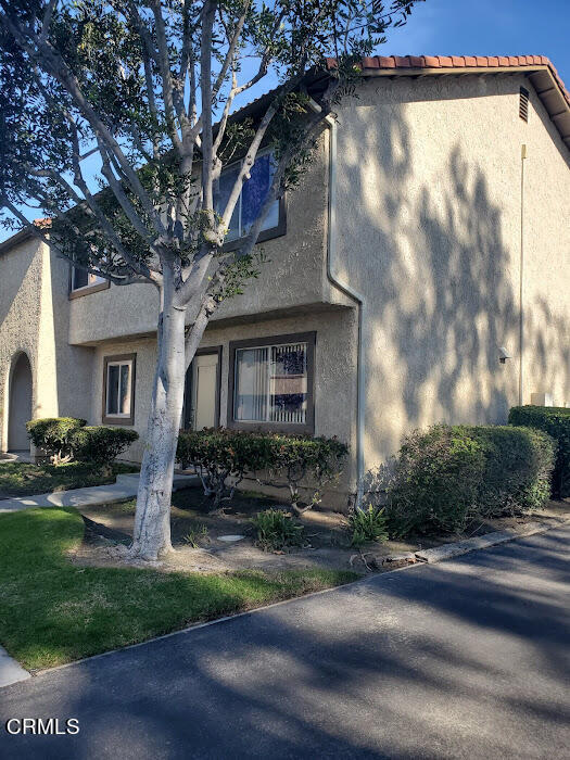 3077 Kelp Lane, Unit 108 Oxnard, CA 93035 - Photo 15 of 15 a front view of a house with yard and green space