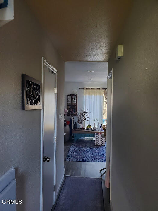 3077 Kelp Lane, Unit 108 Oxnard, CA 93035 - Photo 7 of 15 a view of a hallway to a livingroom and a livingroom with furniture