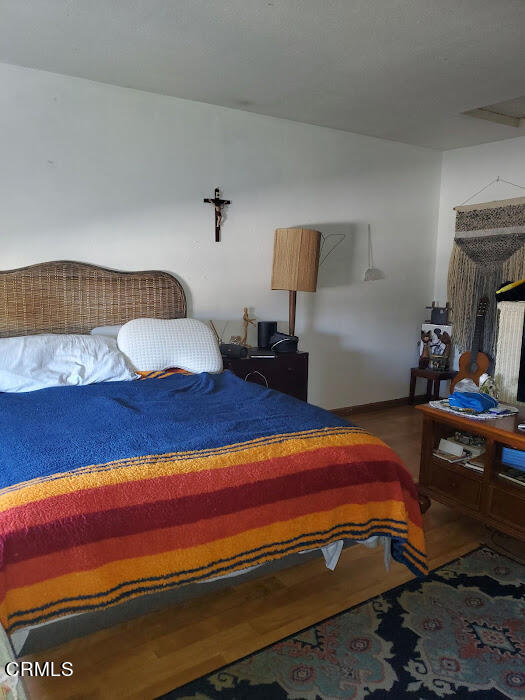 3077 Kelp Lane, Unit 108 Oxnard, CA 93035 - Photo 9 of 15 a bedroom with a bed and a table