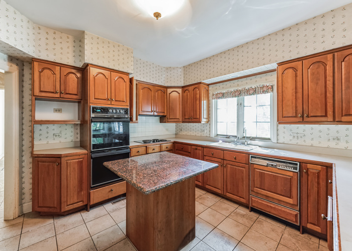 471 Stagecoach Run Glen Ellyn, IL 60137 - Photo 13 of 26 a kitchen with stainless steel appliances granite countertop wooden cabinets a sink and dishwasher
