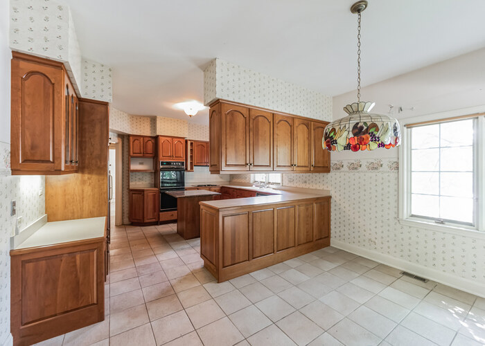 471 Stagecoach Run Glen Ellyn, IL 60137 - Photo 14 of 26 a kitchen with a refrigerator and countertop