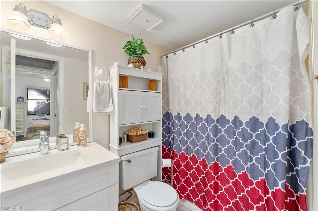 4363 27th Court Southwest, Unit 2103 Naples, FL 34116 - Photo 19 of 30 Guest bathroom with updated vanity with quartz countertop and newer lighting fixture.