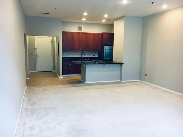 a view of a kitchen with a sink and cabinets