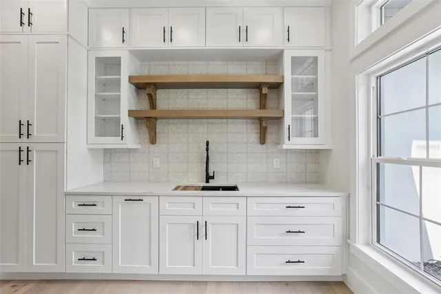 an empty room with a ceiling fan and a window
