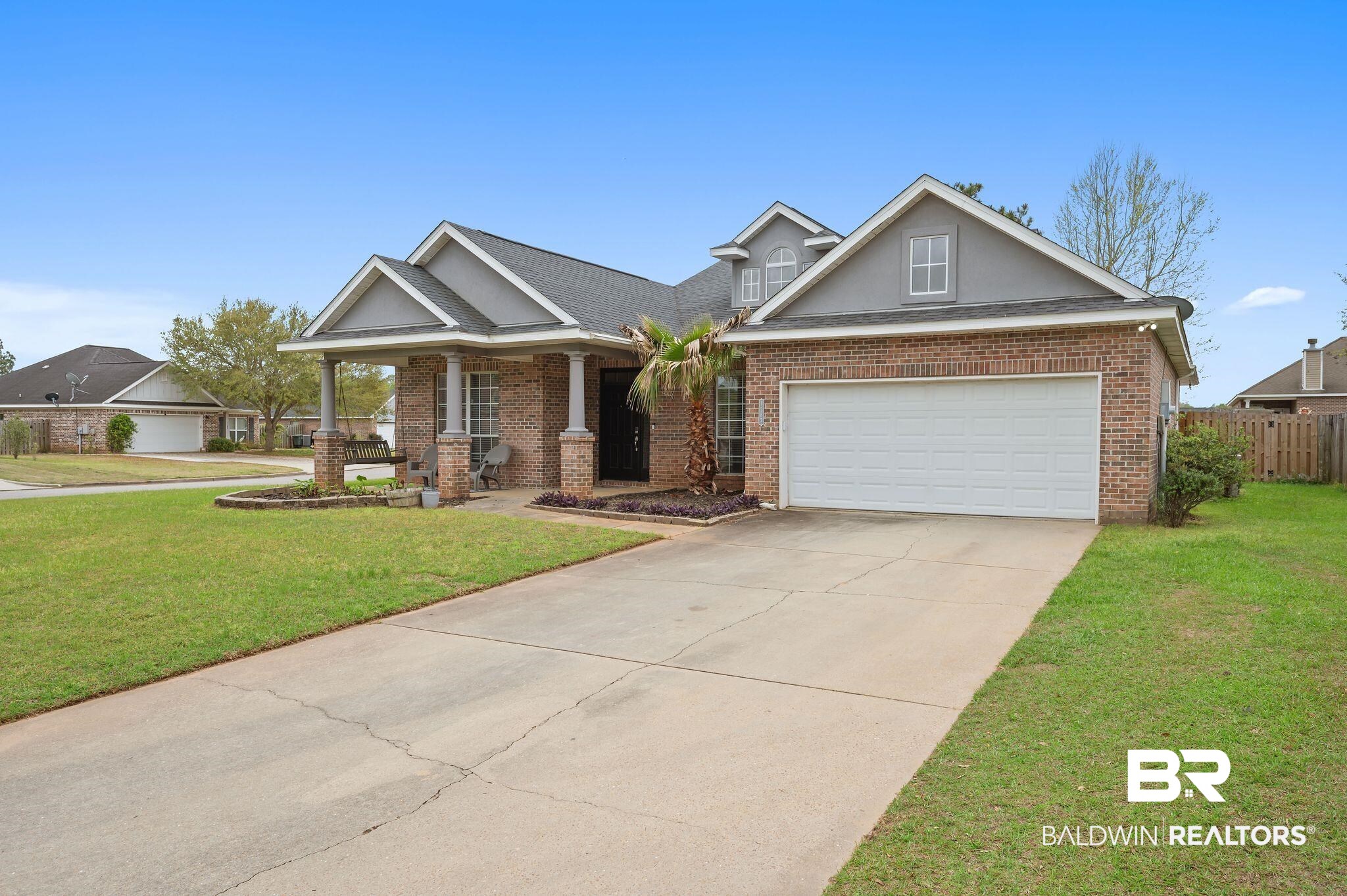 1287 Pembroke Way Foley, AL 36535 - Photo 2 of 39 Craftsman house with brick siding, concrete driveway, a porch, a garage, and a shingled roof