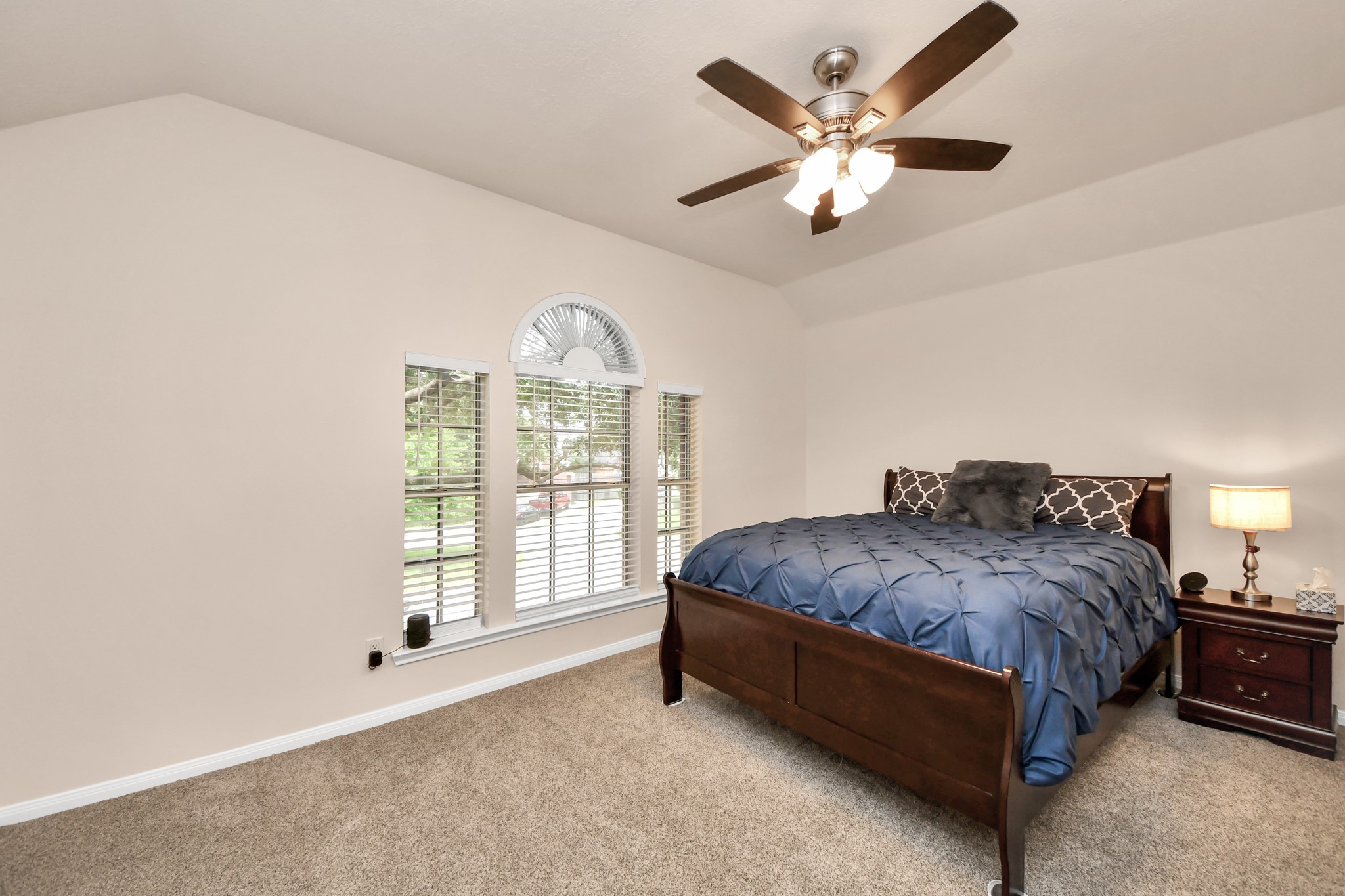 7622 McCormick Mill Court Houston, TX 77095 - Photo 26 of 37 a spacious bedroom with a bed and a large window