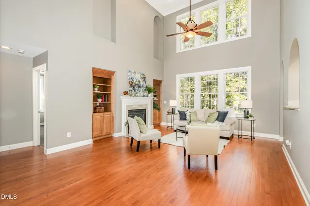 a view of a dining room with furniture a chandelier and wooden floor