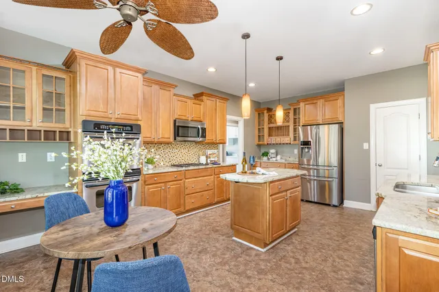 a kitchen with stainless steel appliances granite countertop a refrigerator and a cabinets