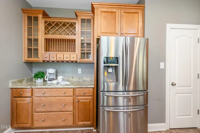 a kitchen with stainless steel appliances wooden floor dining table and chairs