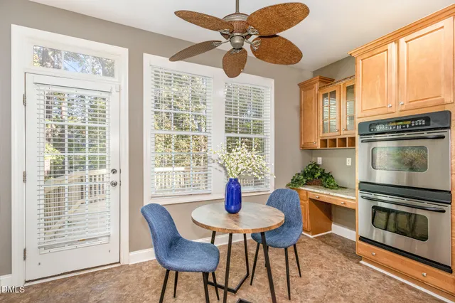 a open kitchen with stainless steel appliances granite countertop a stove top oven a sink dishwasher and couches with wooden floor