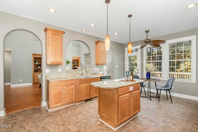 a view of an entryway with wooden floor a mirror and a chandelier