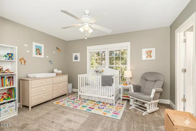 an empty room with windows and chandelier fan
